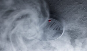 Smoke detector in dark room with smoke